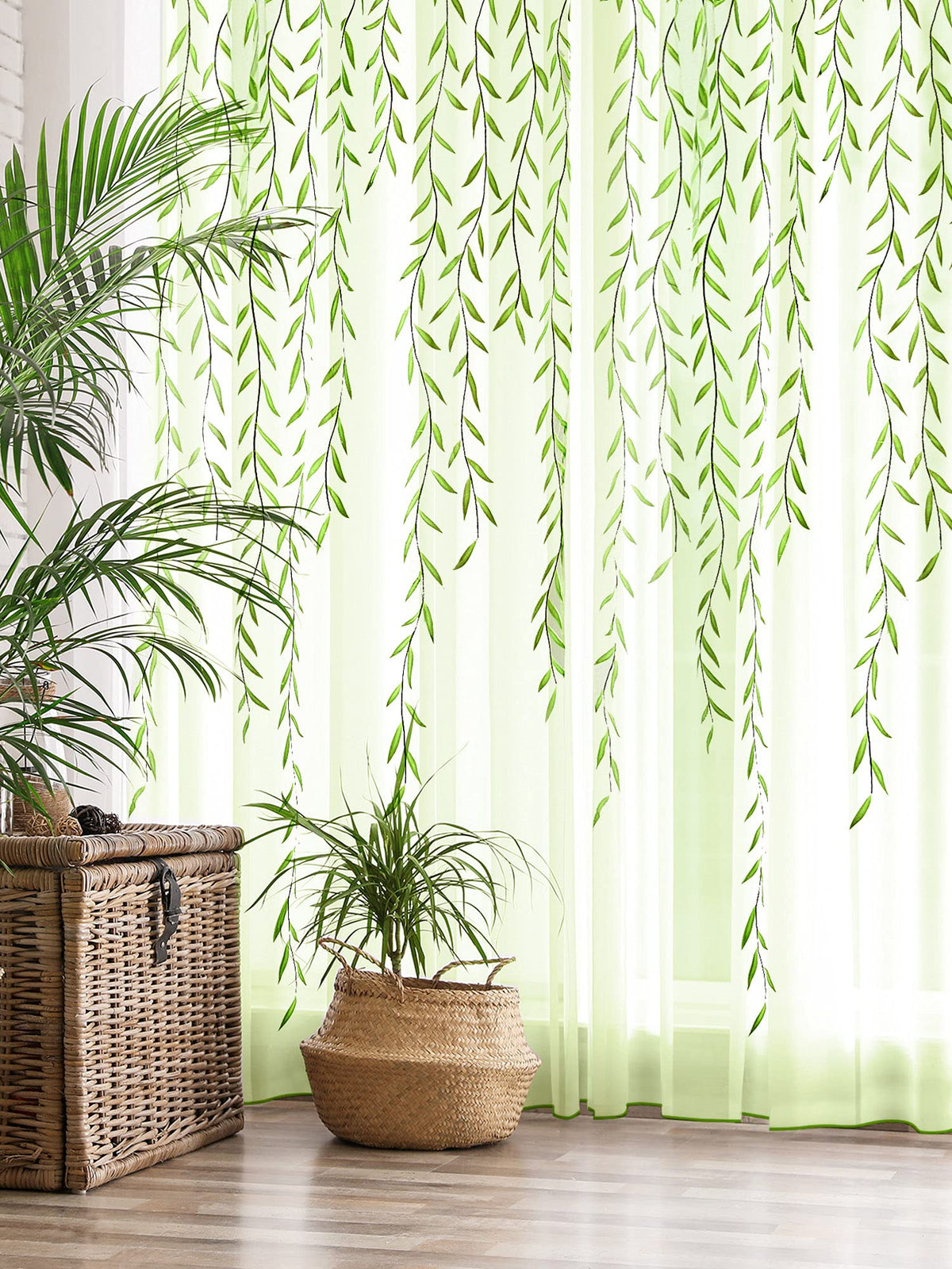 Sheer green leaf curtains in a bright room with indoor plants and natural textures, enhancing the decor.
